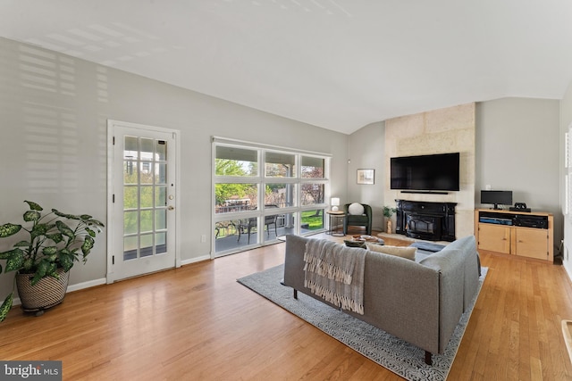 610 Valley Brook Dr, Silver Spring, MD 20904 - living area with baseboards, vaulted ceiling, light wood-style flooring, and a fireplace