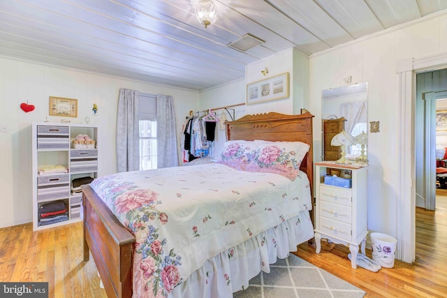 bedroom featuring light wood-type flooring and wood ceiling