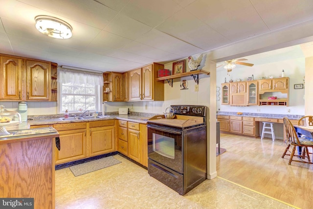 kitchen featuring open shelves, electric range, a sink, ceiling fan, and light flooring
