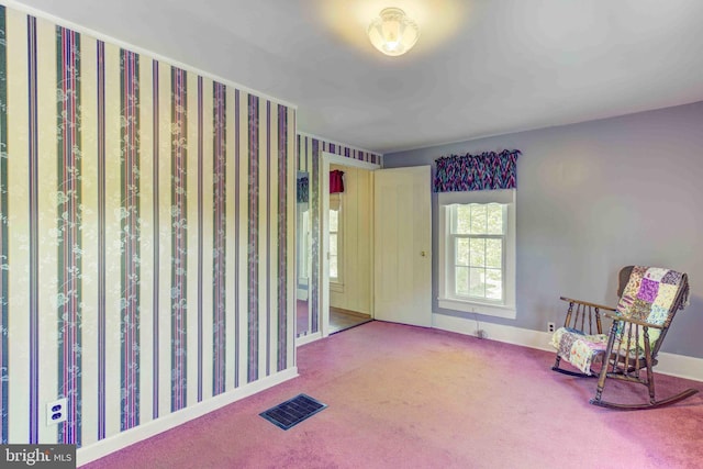 sitting room featuring carpet floors and baseboards
