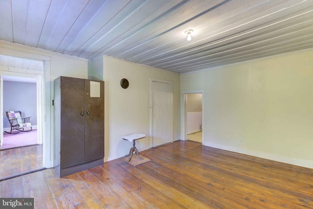 unfurnished room with wood-type flooring and wood ceiling