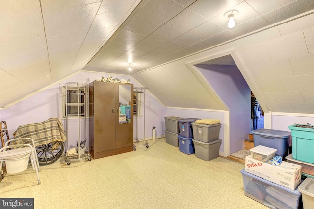bonus room with lofted ceiling and carpet flooring