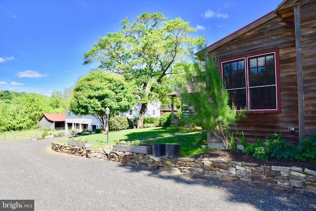 view of side of home featuring a lawn