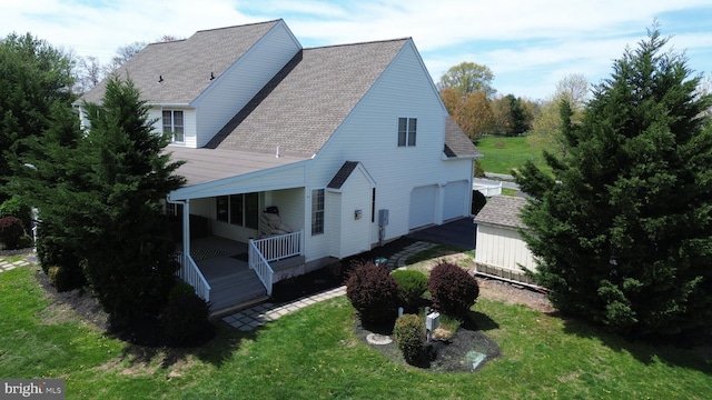 2350 Josie Ln, Harleysville, PA 19438 - view of home's exterior featuring a yard, a porch, a shingled roof, and a garage