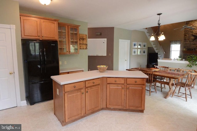 2350 Josie Ln, Harleysville, PA 19438 - kitchen featuring glass insert cabinets, a kitchen island, light countertops, hanging light fixtures, and freestanding refrigerator