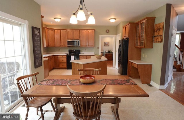 2350 Josie Ln, Harleysville, PA 19438 - kitchen featuring glass insert cabinets, light countertops, black appliances, a kitchen island, and baseboards