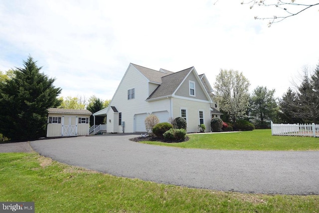 2350 Josie Ln, Harleysville, PA 19438 - view of side of home with aphalt driveway, a shed, an attached garage, fence, and a yard
