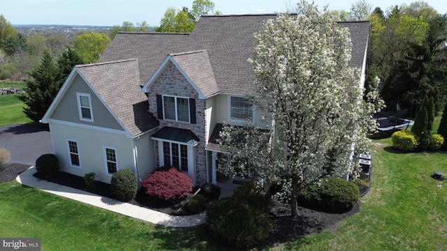 2350 Josie Ln, Harleysville, PA 19438 - view of front of home featuring roof with shingles, a front yard, and stone siding