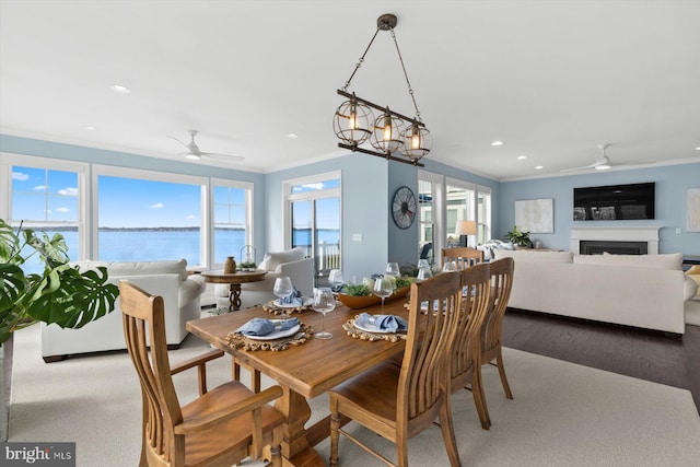 29710 Seagrass Ct, Dagsboro, DE 19939 - dining room with a water view, a fireplace, a ceiling fan, and ornamental molding