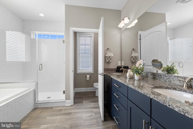 29710 Seagrass Ct, Dagsboro, DE 19939 - bathroom featuring a stall shower, toilet, a sink, a garden tub, and double vanity