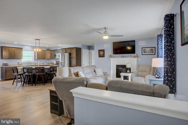 230 Meadowcreek Dr N, Chambersburg, PA 17202 - living room featuring a ceiling fan, light wood-style flooring, recessed lighting, a glass covered fireplace, and visible vents