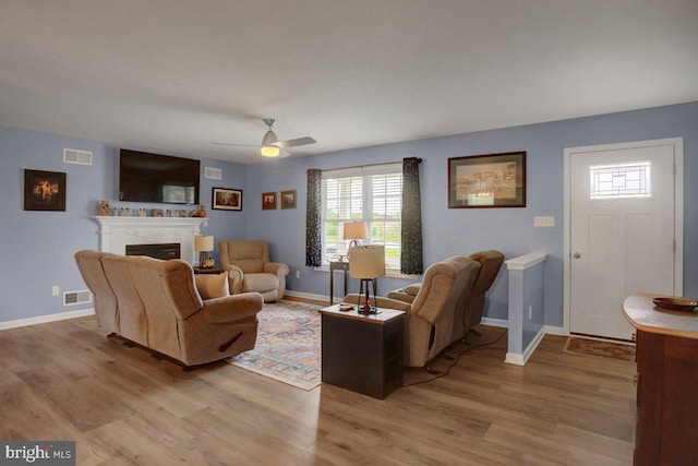 230 Meadowcreek Dr N, Chambersburg, PA 17202 - living area with visible vents, wood finished floors, ceiling fan, and a high end fireplace