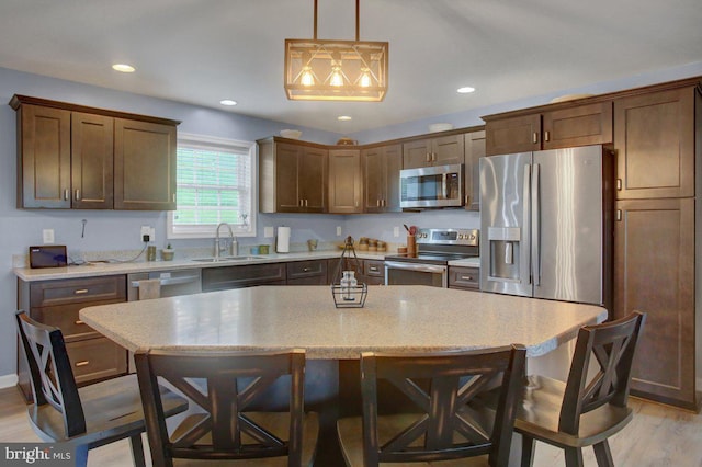 230 Meadowcreek Dr N, Chambersburg, PA 17202 - kitchen featuring stainless steel appliances, light wood-style flooring, a kitchen bar, and a sink
