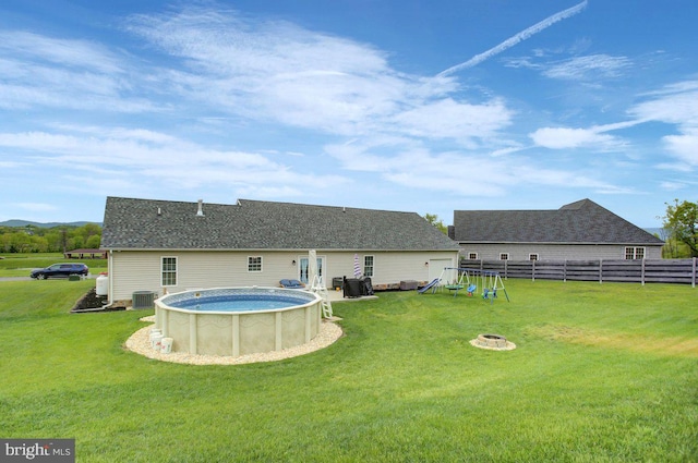 230 Meadowcreek Dr N, Chambersburg, PA 17202 - back of house featuring a yard, fence, cooling unit, an outdoor pool, and a shingled roof