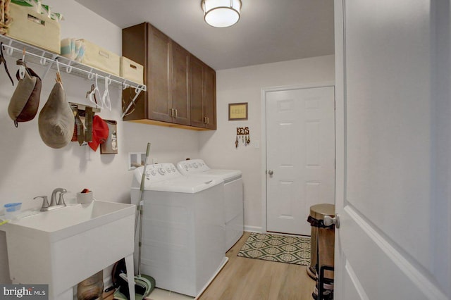 230 Meadowcreek Dr N, Chambersburg, PA 17202 - laundry room with washing machine and dryer, a sink, cabinet space, and light wood-style floors