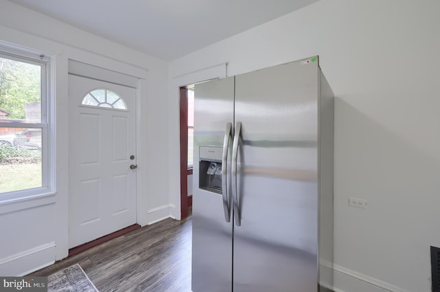 foyer featuring dark wood-type flooring and baseboards