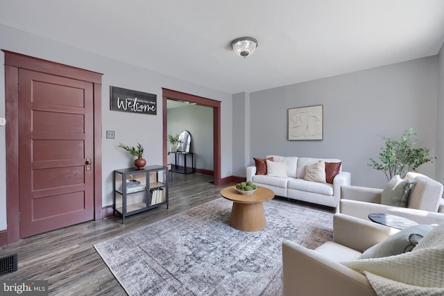 living room with baseboards and wood finished floors
