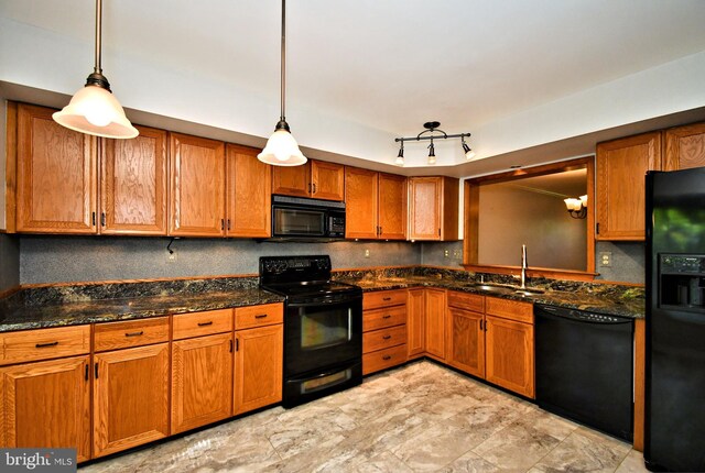 kitchen with a sink, tasteful backsplash, brown cabinetry, and black appliances