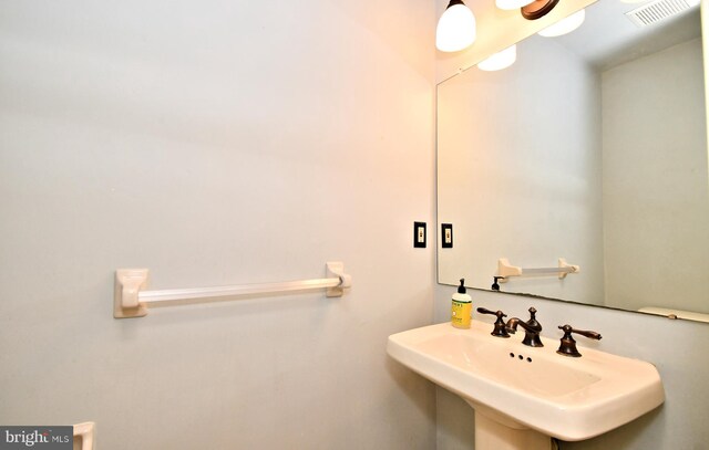bathroom with visible vents and a sink