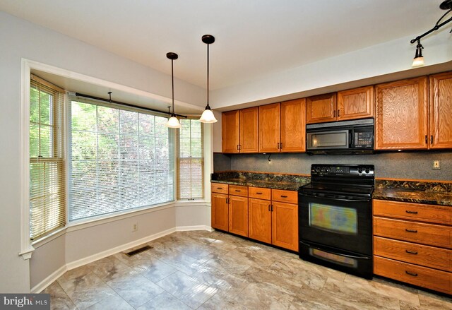 kitchen with brown cabinets, visible vents, and black appliances