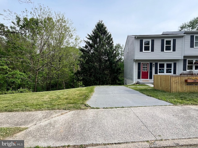 28 Wenner Dr, Brunswick, MD 21716 - view of front facade with concrete driveway, a front lawn, and fence