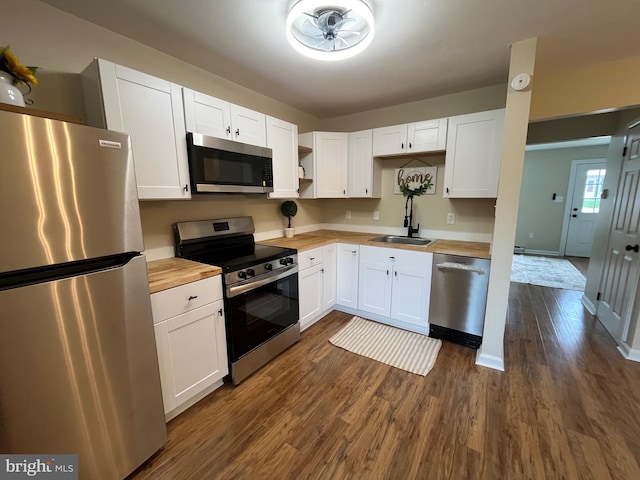 28 Wenner Dr, Brunswick, MD 21716 - kitchen featuring butcher block countertops, a sink, stainless steel appliances, dark wood-style flooring, and white cabinets