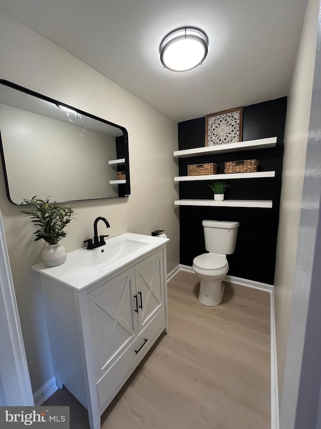 28 Wenner Dr, Brunswick, MD 21716 - half bath featuring vanity, baseboards, toilet, and wood finished floors