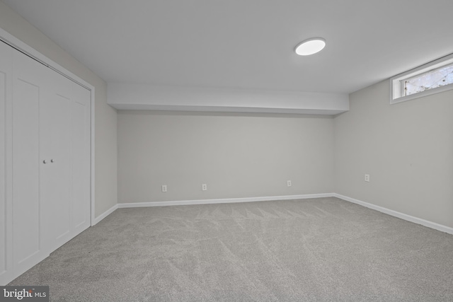 basement featuring carpet flooring and baseboards