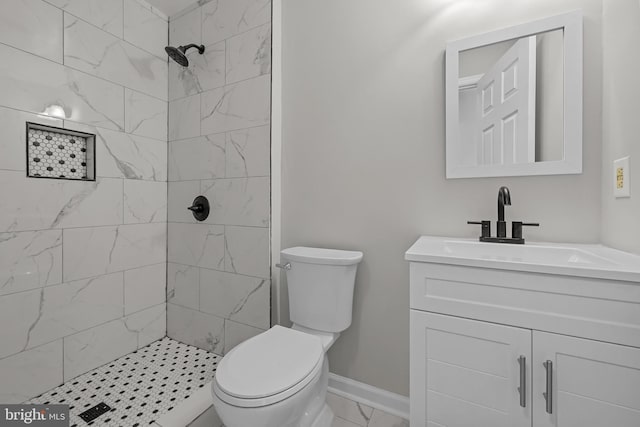 full bathroom with vanity, toilet, marble finish floor, and tiled shower