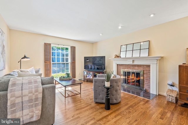 living area with wood finished floors and a fireplace