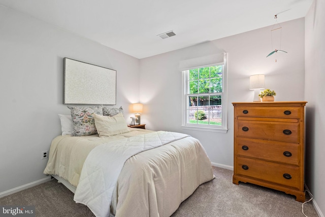 bedroom featuring light colored carpet, baseboards, and visible vents