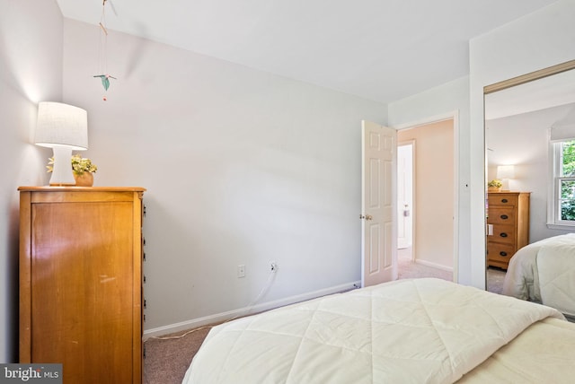 carpeted bedroom with baseboards