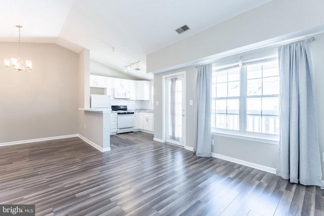 645 Constellation Sq SE Unit L, Leesburg, VA 20175 - unfurnished living room with visible vents, a notable chandelier, rail lighting, lofted ceiling, and dark wood-type flooring