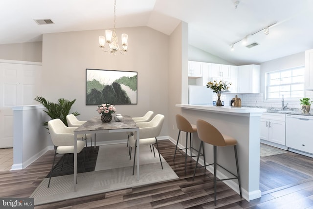 645 Constellation Sq SE Unit L, Leesburg, VA 20175 - dining room with a notable chandelier, vaulted ceiling, dark wood-style floors, and visible vents