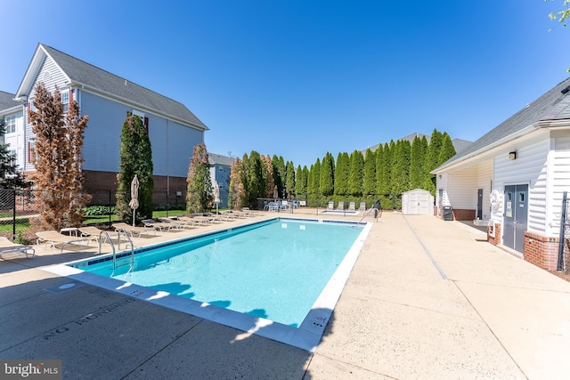 645 Constellation Sq SE Unit L, Leesburg, VA 20175 - pool featuring a storage shed, a patio, fence, and an outdoor structure