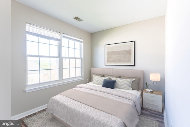 645 Constellation Sq SE Unit L, Leesburg, VA 20175 - bedroom with visible vents, baseboards, and wood finished floors