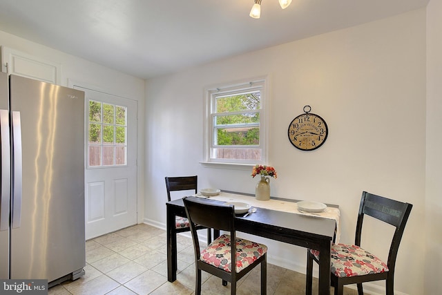 dining room featuring light tile patterned flooring and baseboards