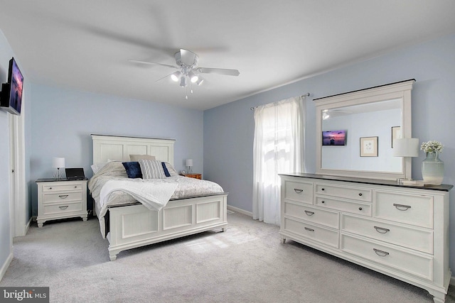 bedroom featuring baseboards, a ceiling fan, and light carpet