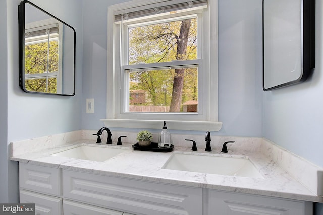 bathroom featuring double vanity and a sink