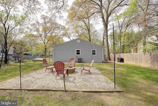view of patio with a fire pit, cooling unit, and fence private yard