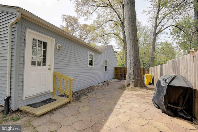 exterior space with fence and a grill