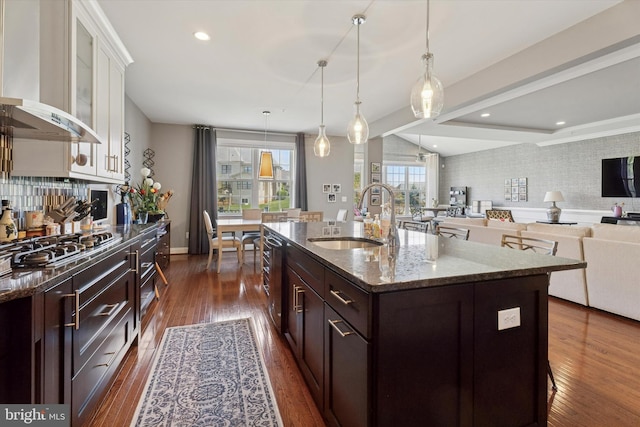 6179 Creekside Dr, Flourtown, PA 19031 - kitchen featuring a sink, dark stone countertops, dark wood-type flooring, dark brown cabinetry, and wall chimney range hood