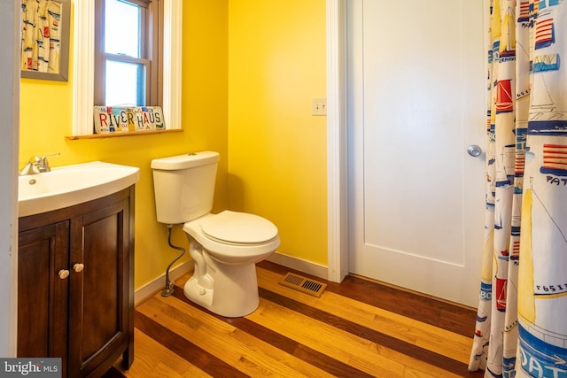 3734 1st Ave, Edgewater, MD 21037 - full bath with visible vents, baseboards, toilet, wood finished floors, and vanity