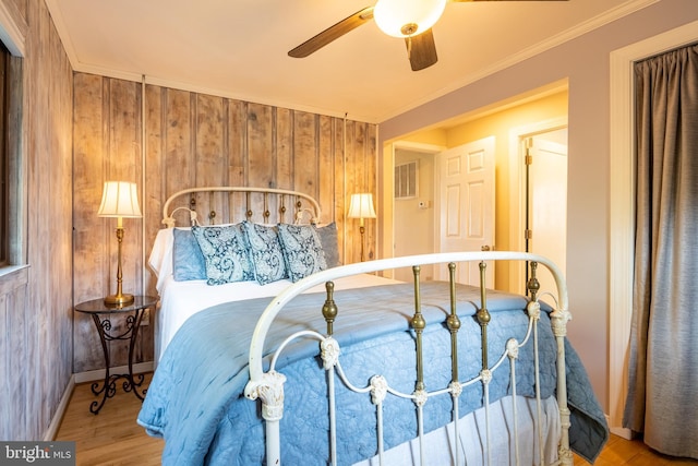 3734 1st Ave, Edgewater, MD 21037 - bedroom featuring wood walls, wood finished floors, crown molding, and baseboards