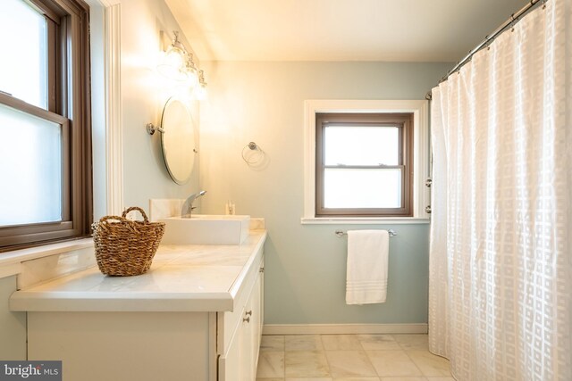 3734 1st Ave, Edgewater, MD 21037 - bathroom with baseboards, plenty of natural light, vanity, and marble finish floor