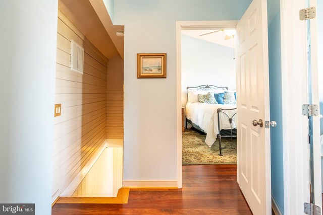 3734 1st Ave, Edgewater, MD 21037 - corridor featuring baseboards, wood walls, and dark wood-type flooring
