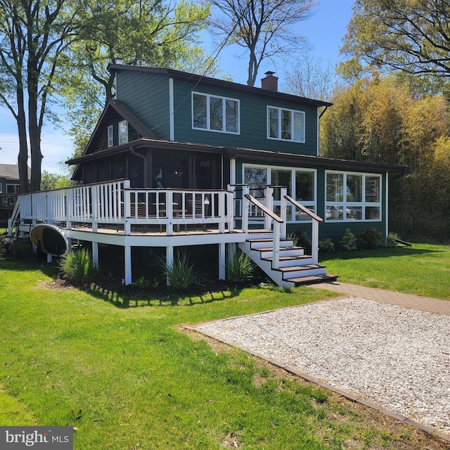 3734 1st Ave, Edgewater, MD 21037 - rear view of house with a lawn, a chimney, and a deck