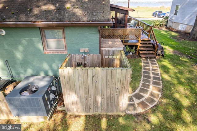 3734 1st Ave, Edgewater, MD 21037 - back of house with fence, ac unit, stucco siding, stairway, and a deck with water view