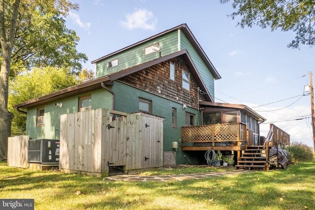 3734 1st Ave, Edgewater, MD 21037 - back of property with a lawn, central air condition unit, a sunroom, and a wooden deck