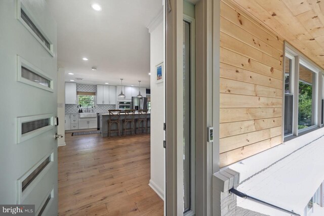 interior space featuring recessed lighting, a sink, and hardwood / wood-style flooring